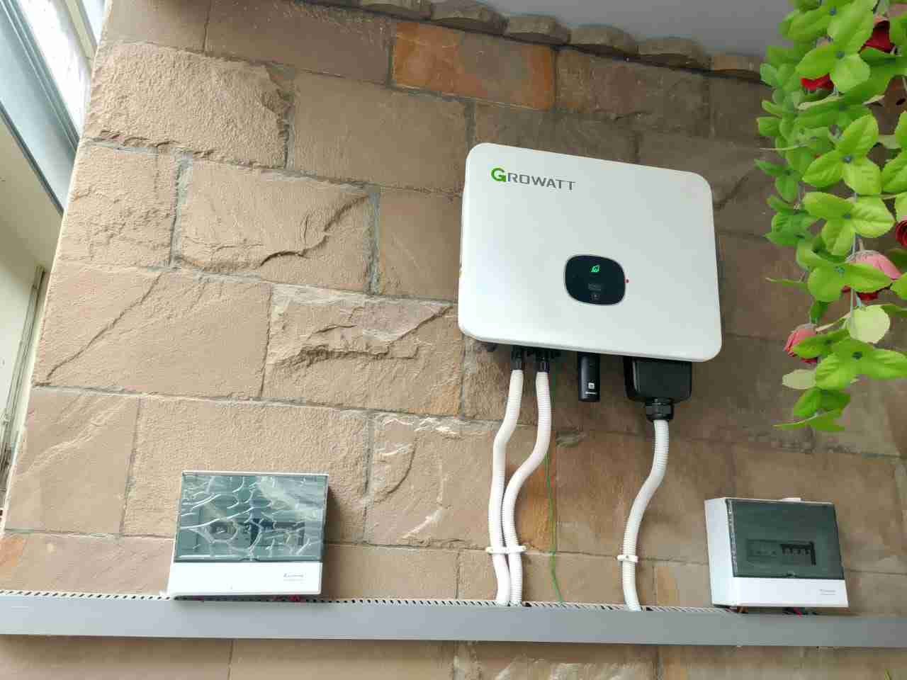 Growatt solar inverter installed on wall.