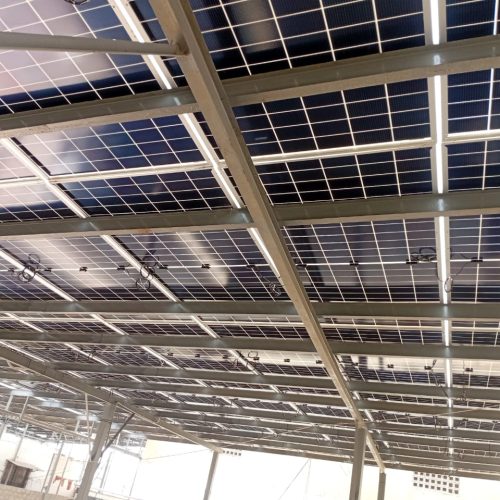 Solar panels installed on the roof of a modern building, harnessing renewable energy from the sun.