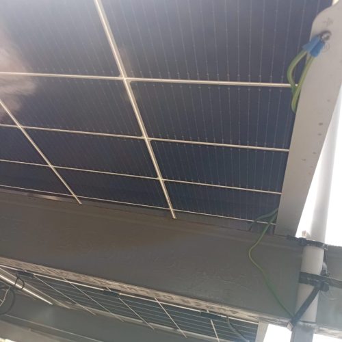 A solar panel installed on the roof of a modern building, harnessing renewable energy from the sun.