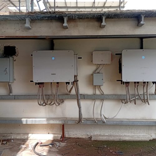 Multiple electrical boxes mounted on a wall, interconnected with wires for power distribution.