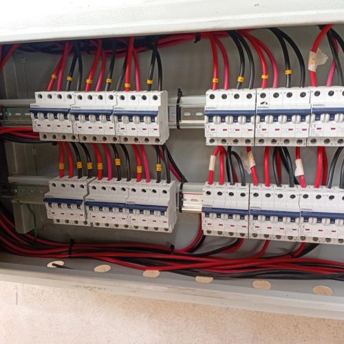 A panel containing various wires and electrical equipment, showcasing a complex electrical setup.